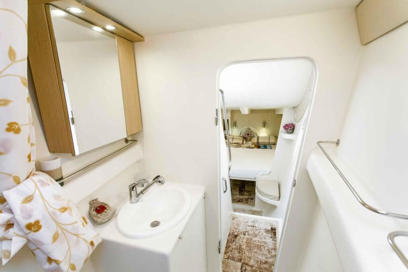 a bathroom with a sink and a mirror aboard CONAN Yacht for Sale