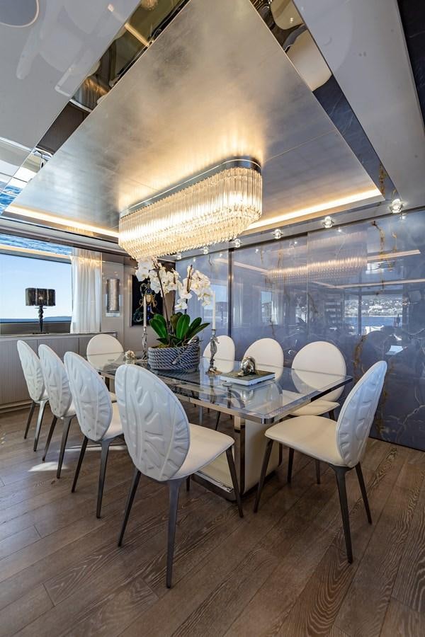 a room with a table and chairs aboard SL118 #653 Yacht for Sale