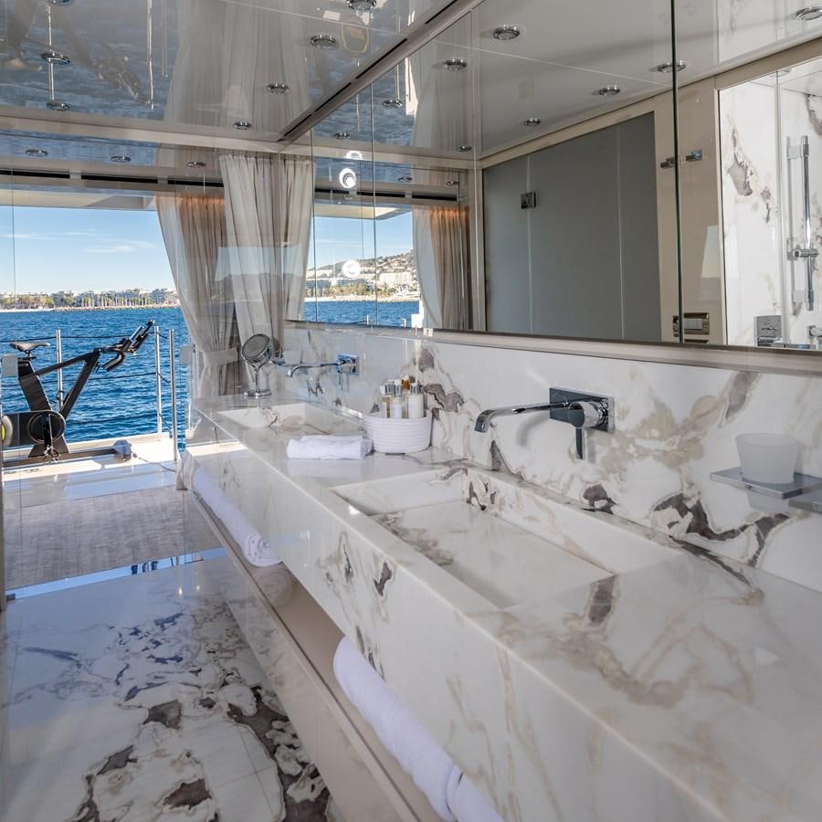 a bathroom with a tub sink and a large window aboard SL118 #653 Yacht for Sale