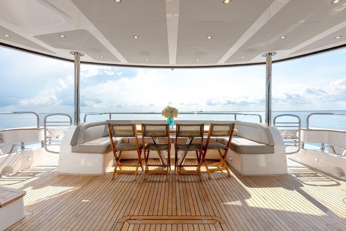a boat with a table and chairs on the deck aboard TRIGGER HAPPY Yacht for Sale