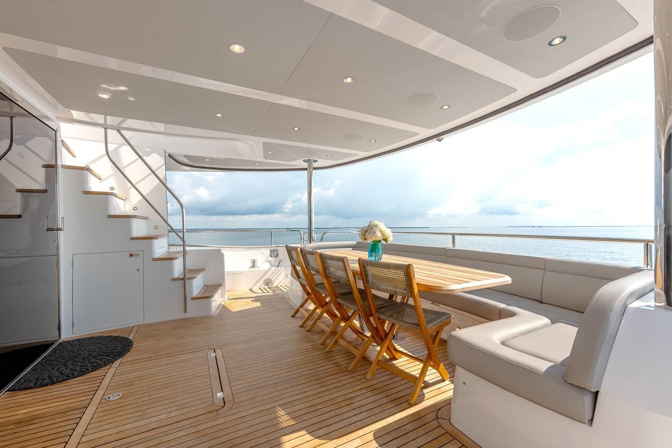 a large open space with a table and chairs and a large window aboard TRIGGER HAPPY Yacht for Sale