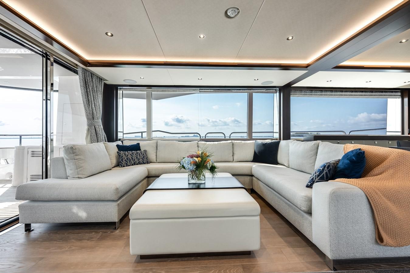 a living room with a couch and a coffee table aboard TRIGGER HAPPY Yacht for Sale