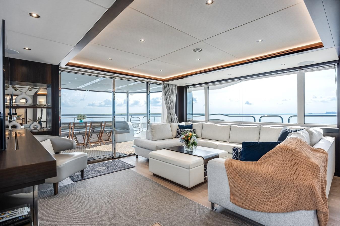 a living room with a large window aboard TRIGGER HAPPY Yacht for Sale