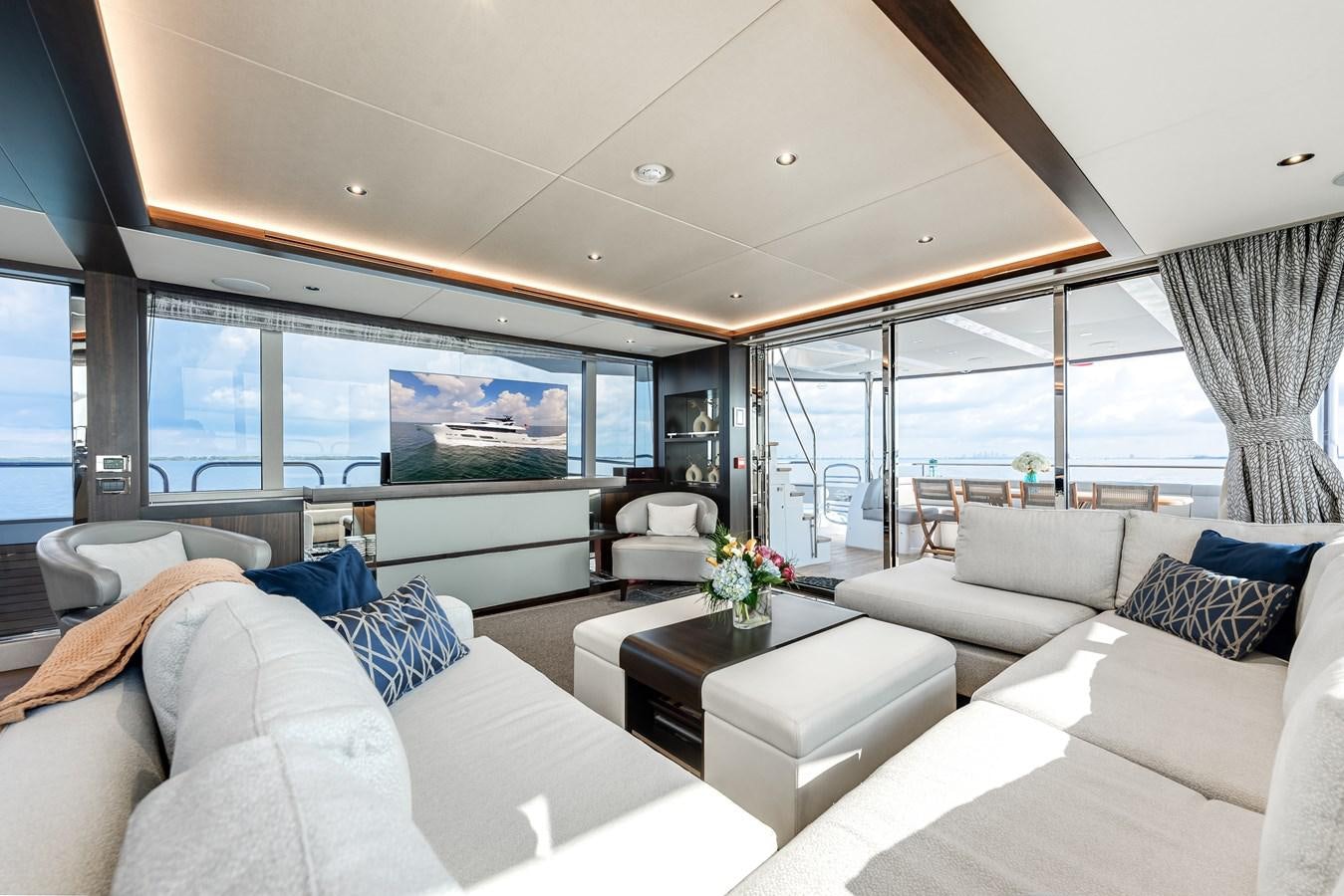 a living room with a large window aboard TRIGGER HAPPY Yacht for Sale