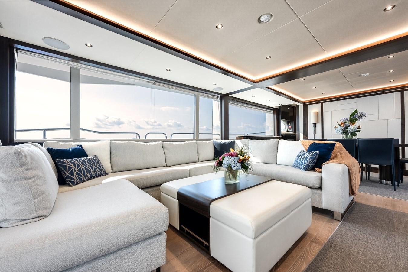 a living room with a large window aboard TRIGGER HAPPY Yacht for Sale