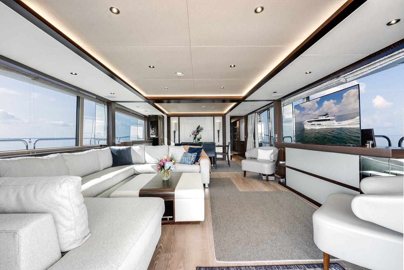 a room with a couch and a table and a tv aboard TRIGGER HAPPY Yacht for Sale