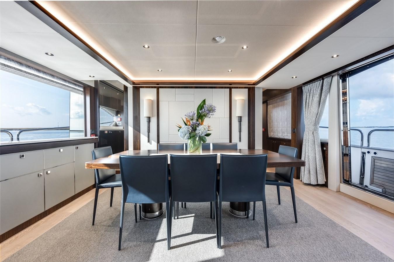 a large kitchen with a dining table aboard TRIGGER HAPPY Yacht for Sale