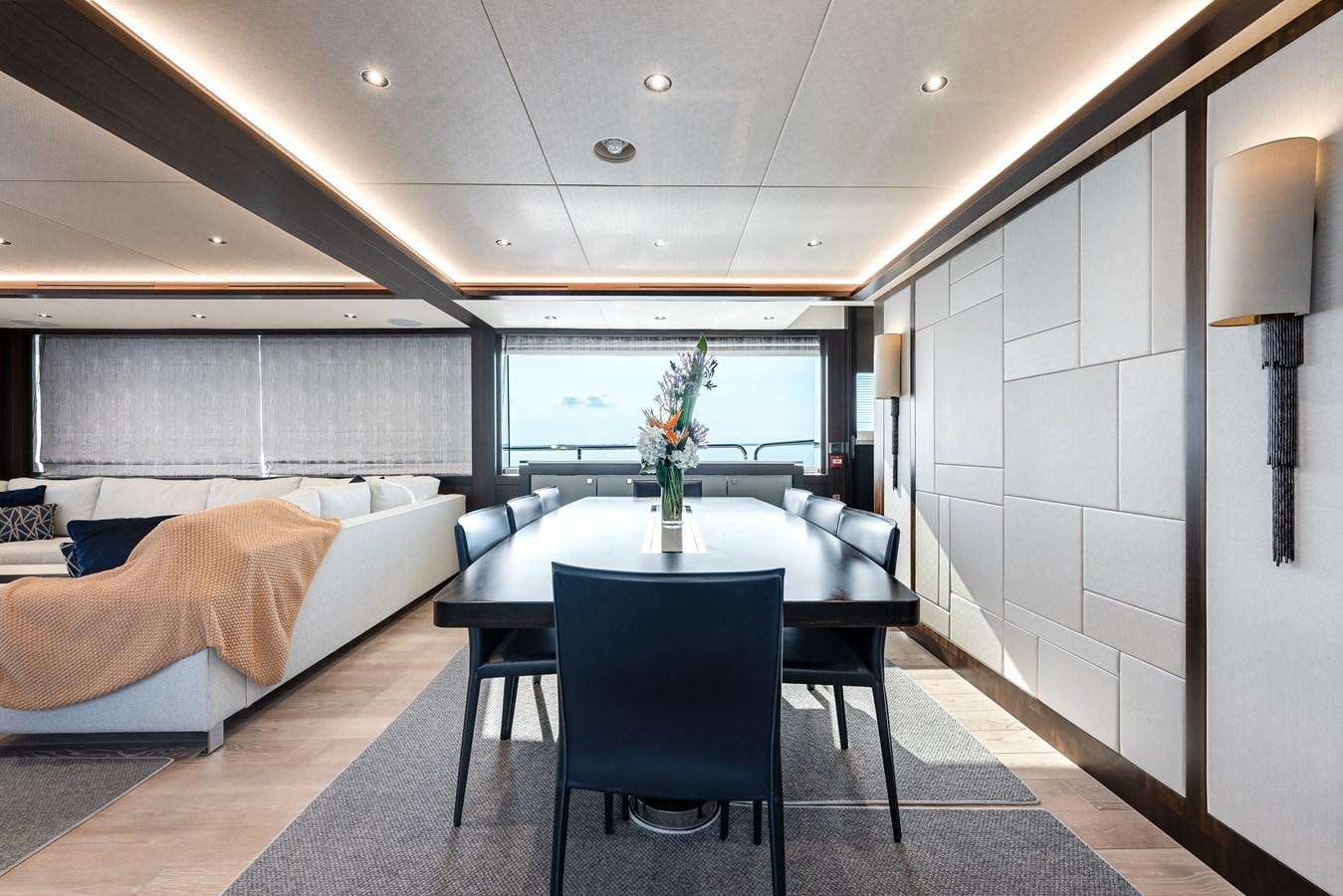 a room with a bed and a table aboard TRIGGER HAPPY Yacht for Sale