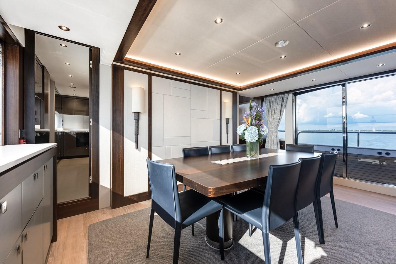 a large kitchen with a table and chairs aboard TRIGGER HAPPY Yacht for Sale