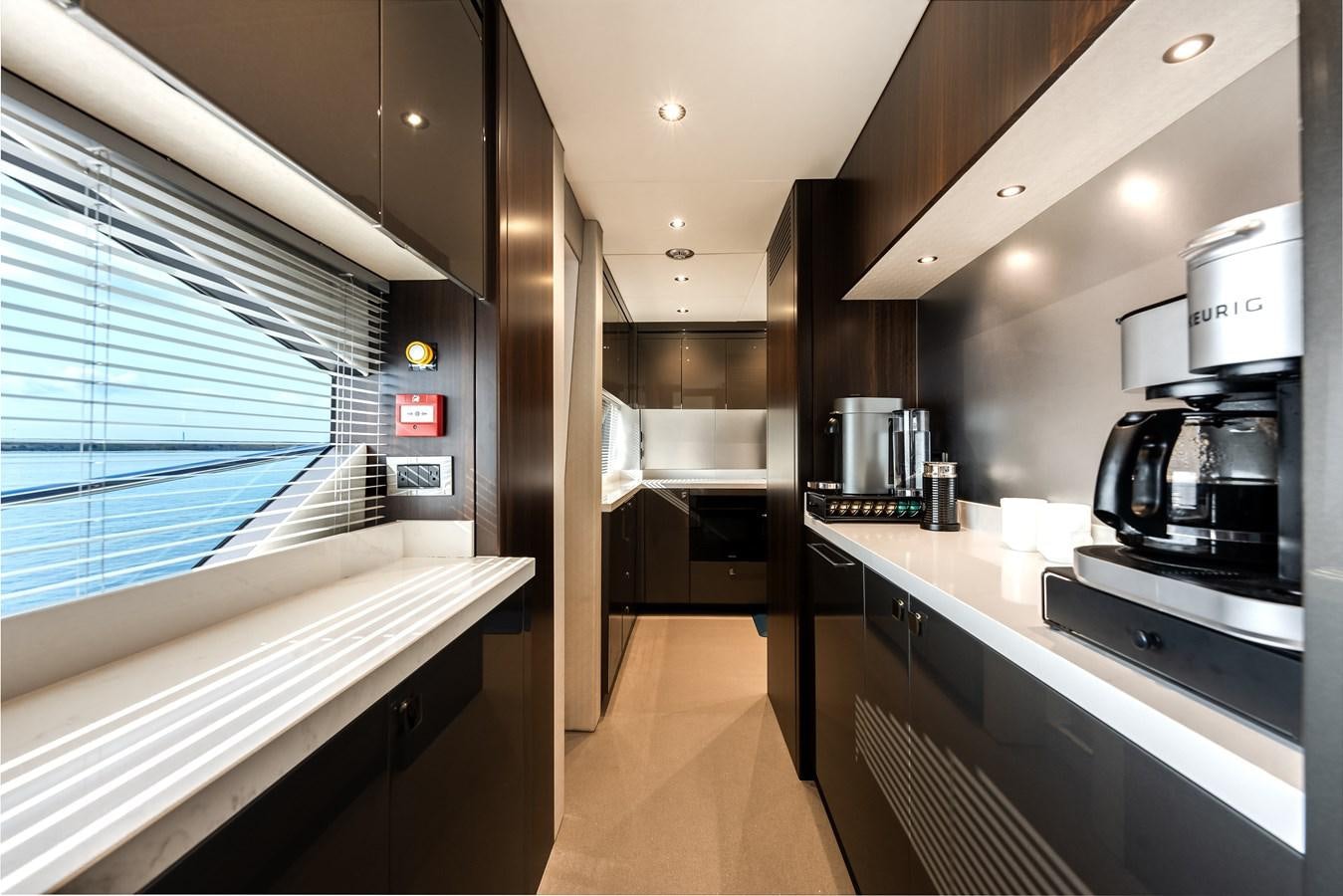 a kitchen with a large window aboard TRIGGER HAPPY Yacht for Sale