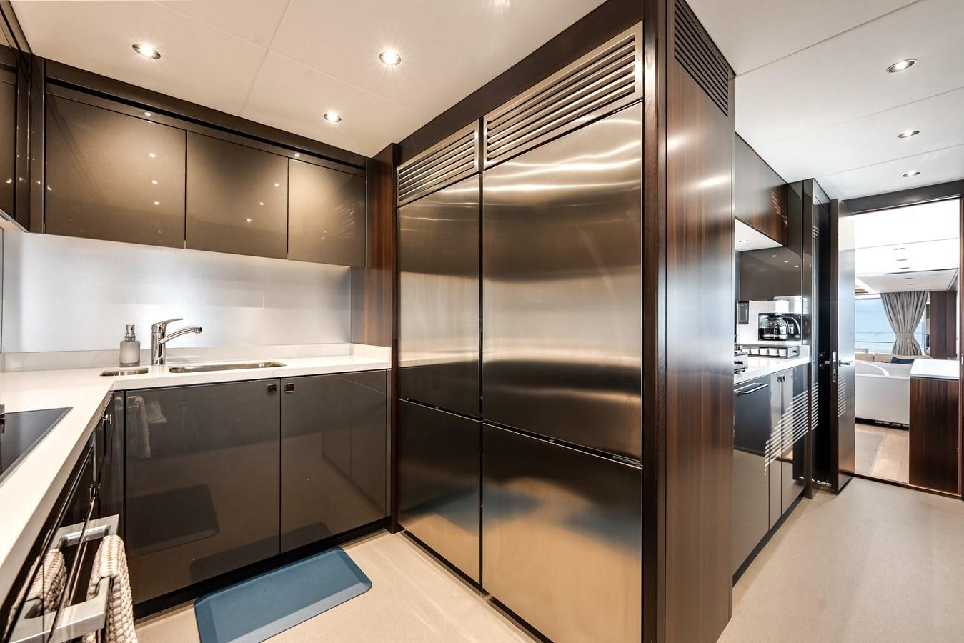 a kitchen with a glass shower aboard TRIGGER HAPPY Yacht for Sale
