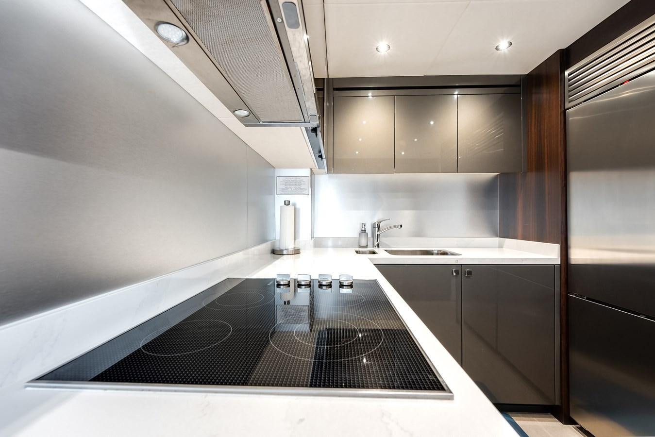 a kitchen with a large island aboard TRIGGER HAPPY Yacht for Sale
