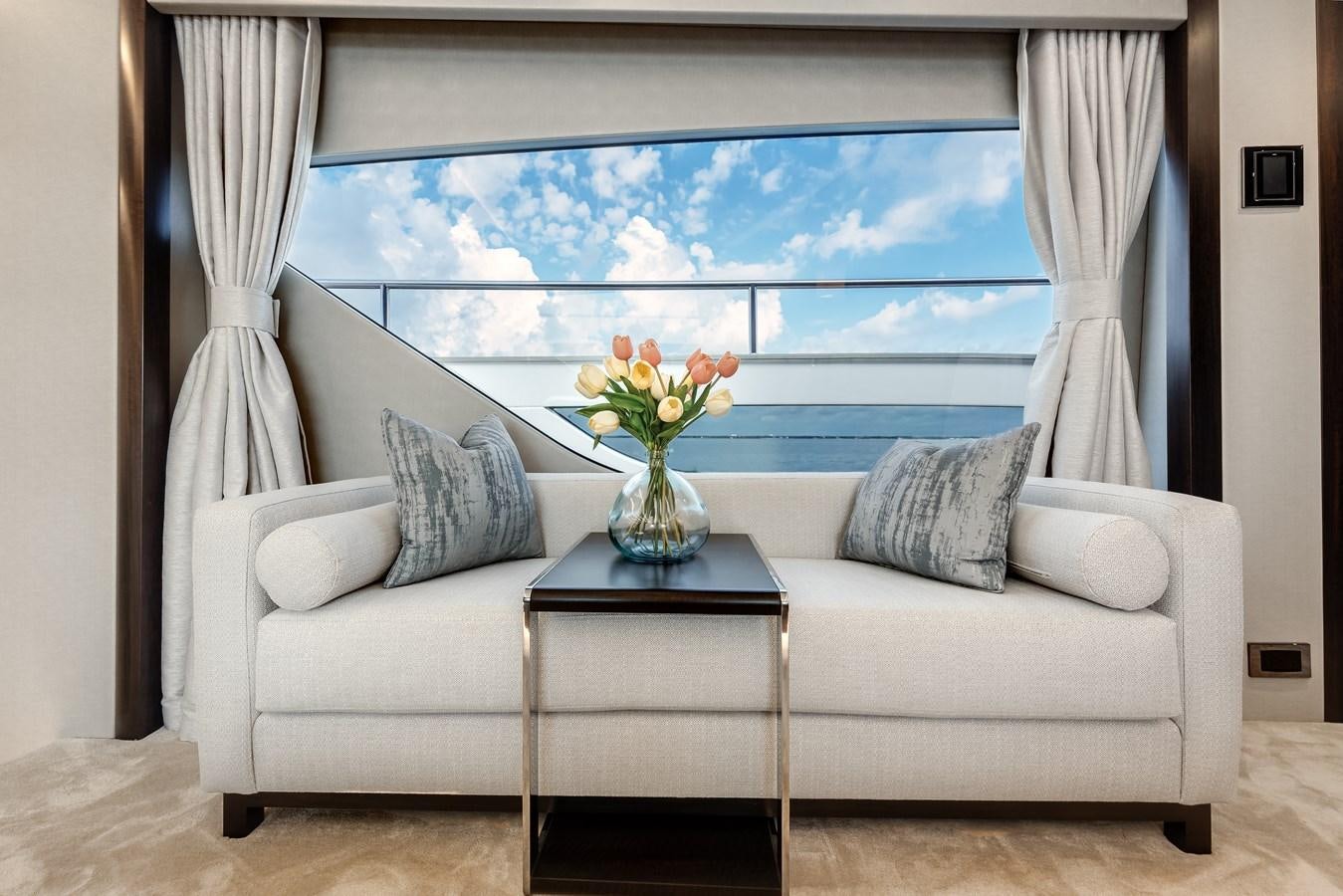 a living room with a vase of flowers on a table aboard TRIGGER HAPPY Yacht for Sale