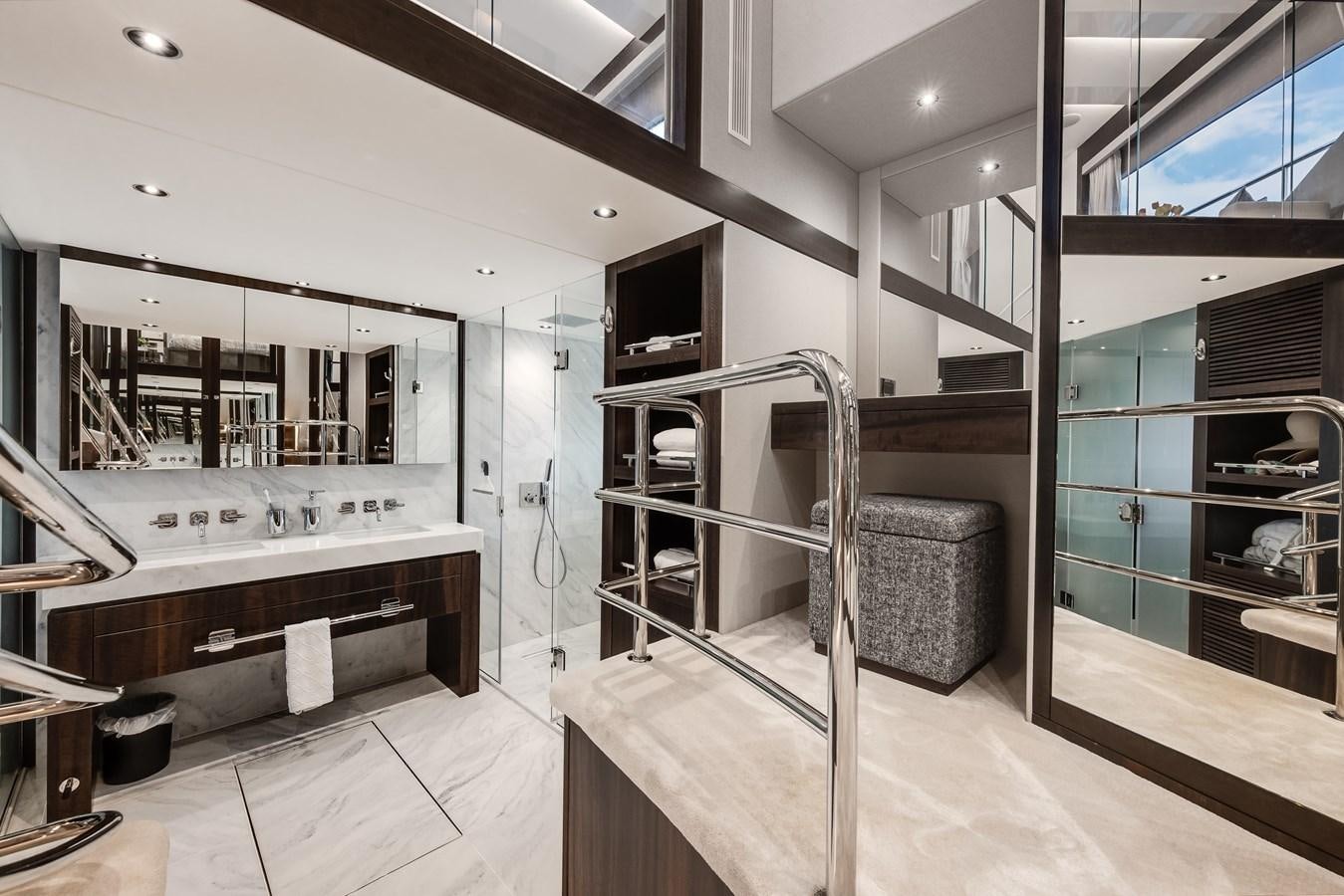a bathroom with a tub sink and a mirror aboard TRIGGER HAPPY Yacht for Sale