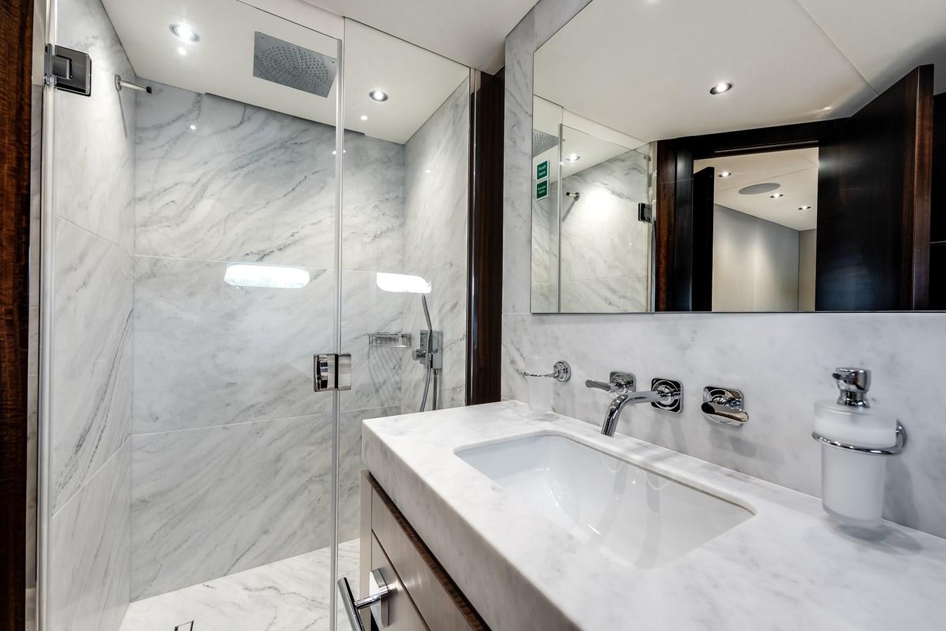 a bathroom with a large mirror aboard TRIGGER HAPPY Yacht for Sale