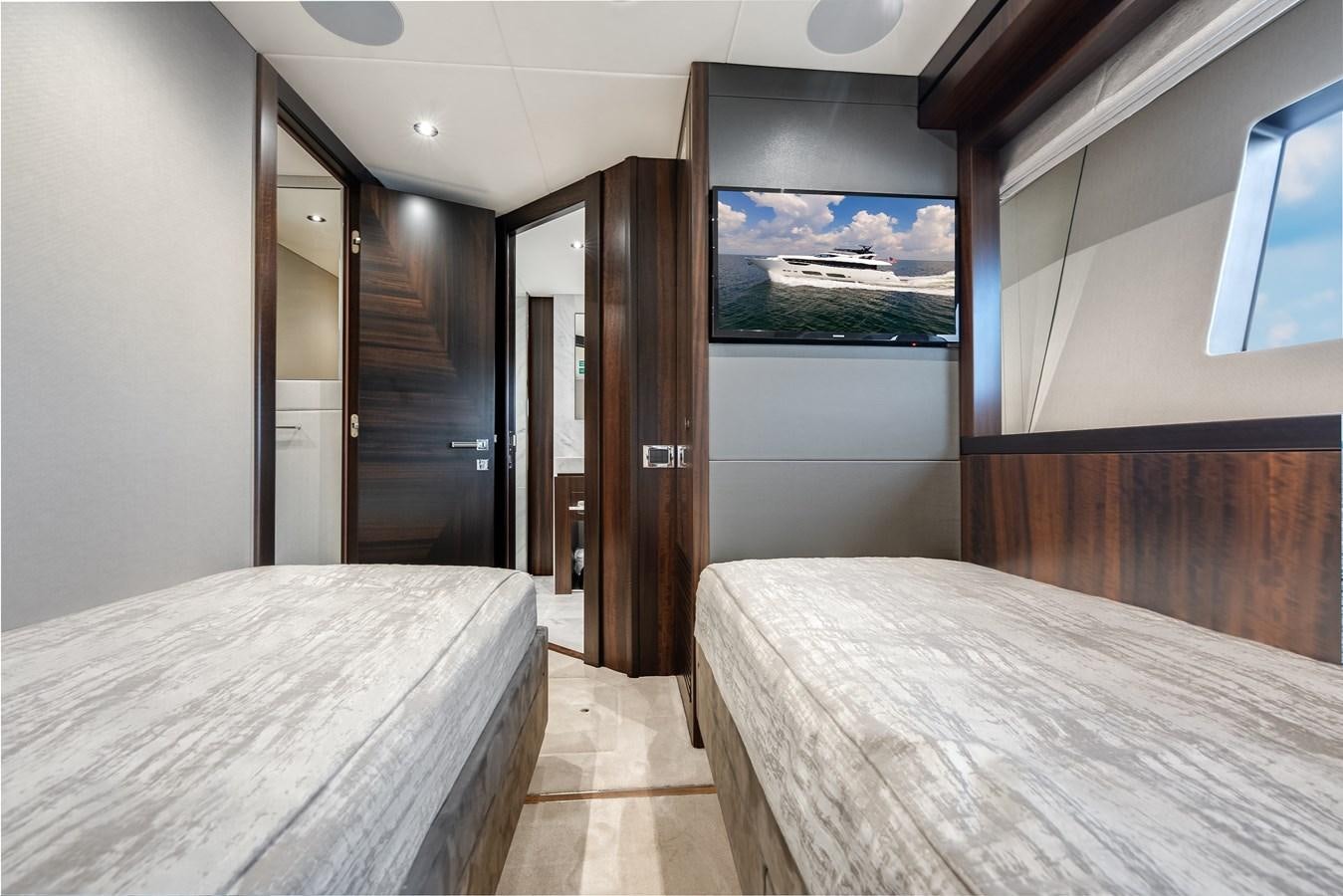 a room with a bed and a door aboard TRIGGER HAPPY Yacht for Sale