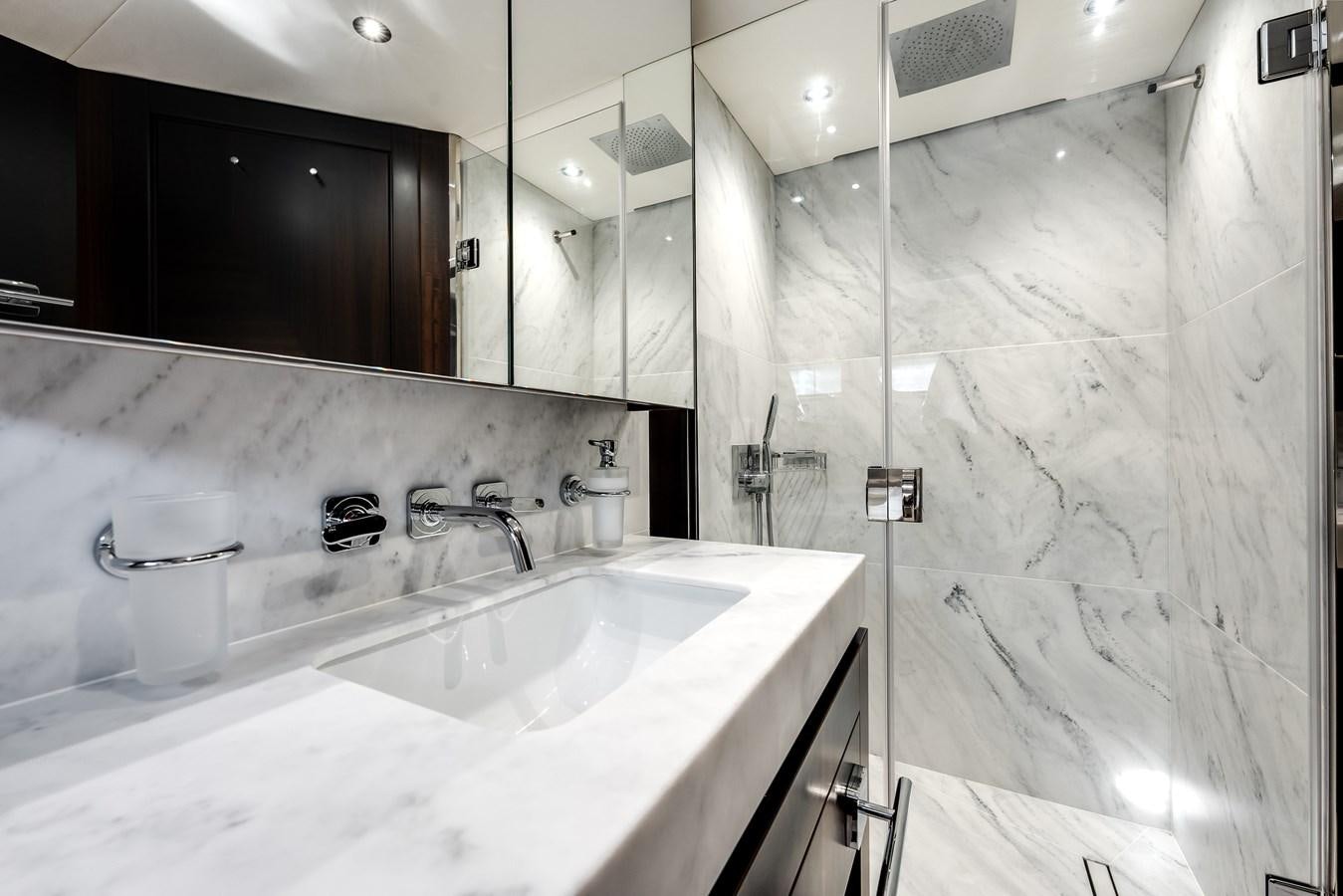 a bathroom with a large mirror aboard TRIGGER HAPPY Yacht for Sale