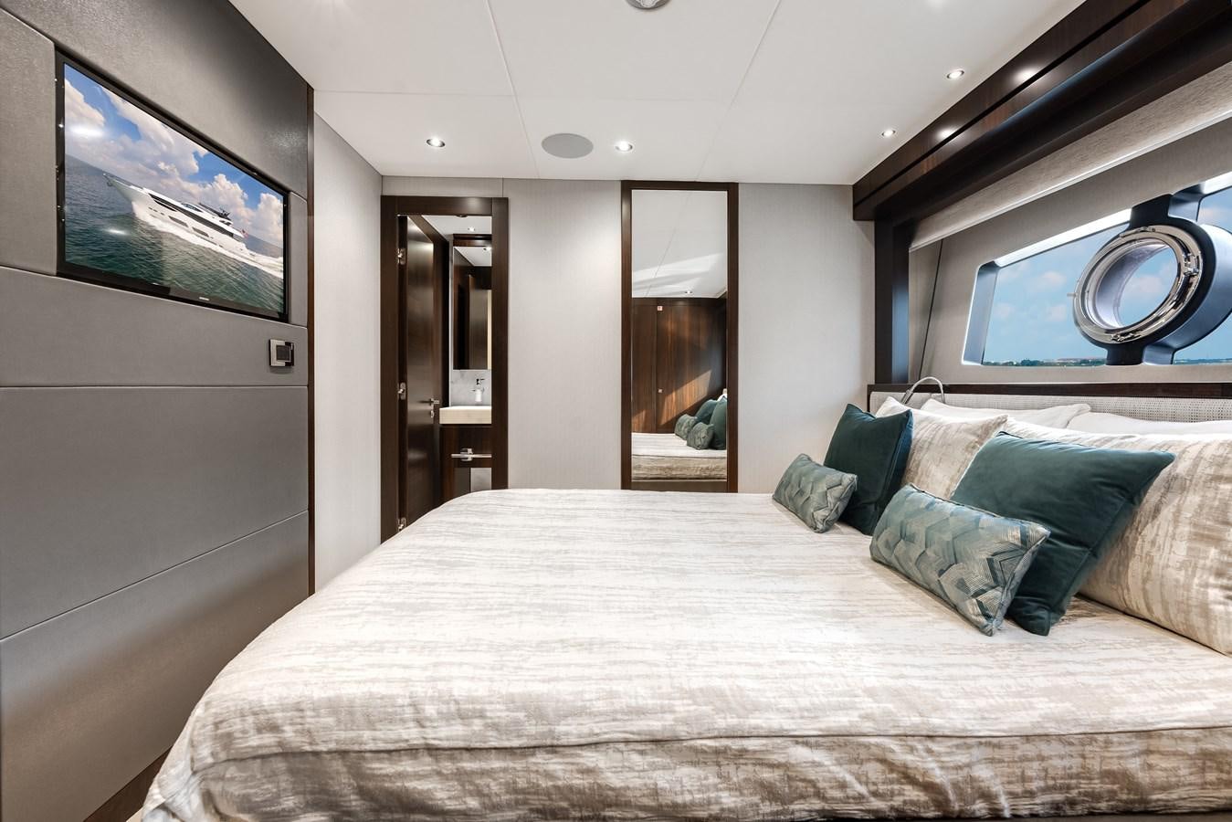 a bed with pillows and a mirror aboard TRIGGER HAPPY Yacht for Sale