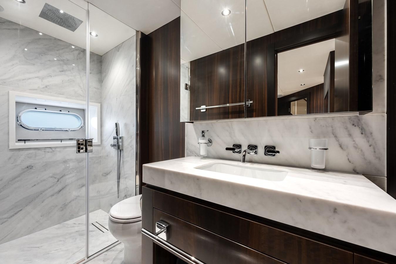 a bathroom with a large mirror aboard TRIGGER HAPPY Yacht for Sale