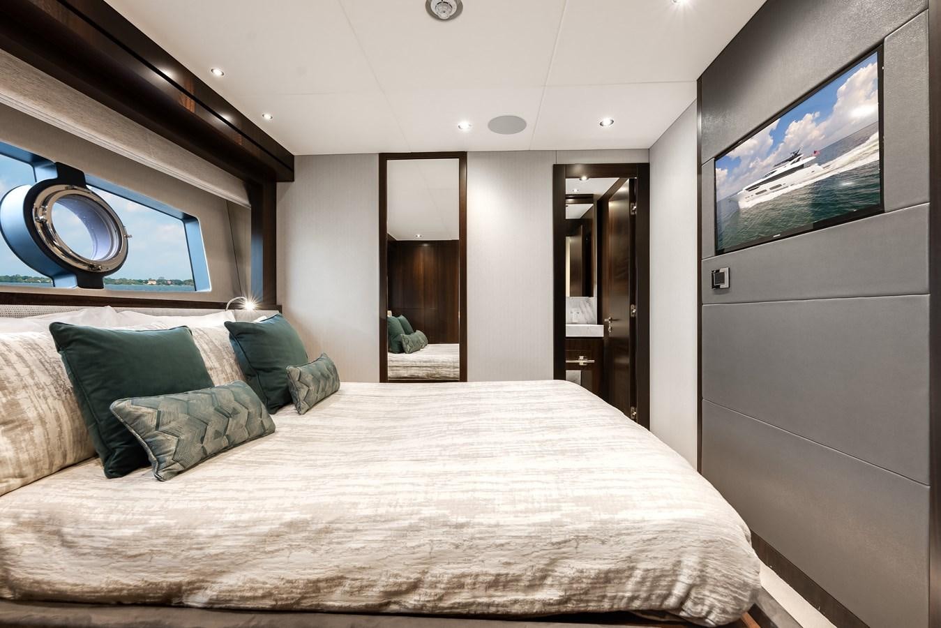 a bed with a white bed spread aboard TRIGGER HAPPY Yacht for Sale