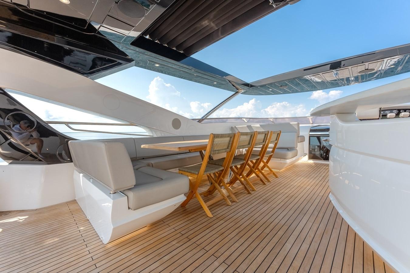 a room with a couch and chairs aboard TRIGGER HAPPY Yacht for Sale