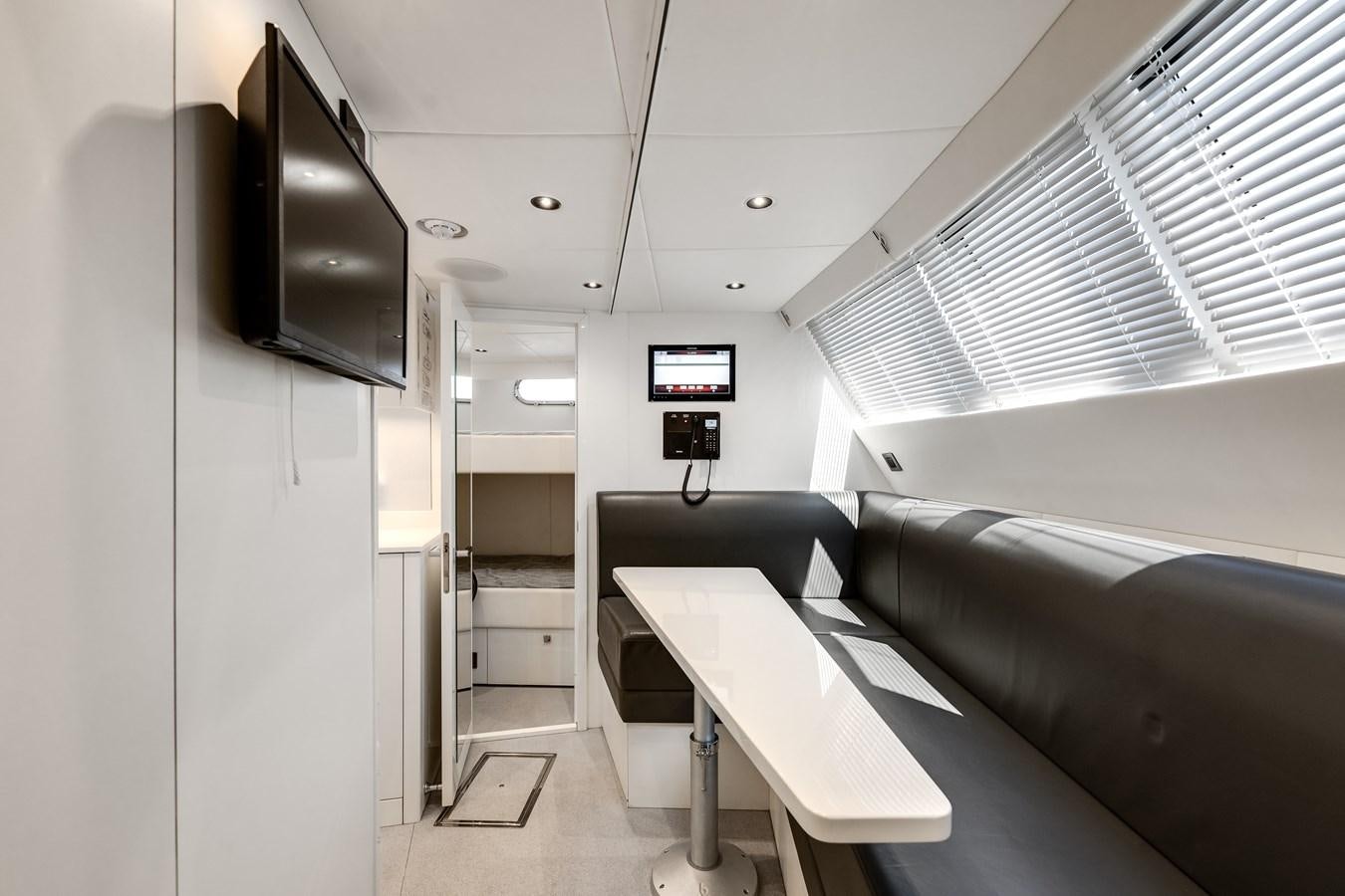 a room with a desk and a tv aboard TRIGGER HAPPY Yacht for Sale