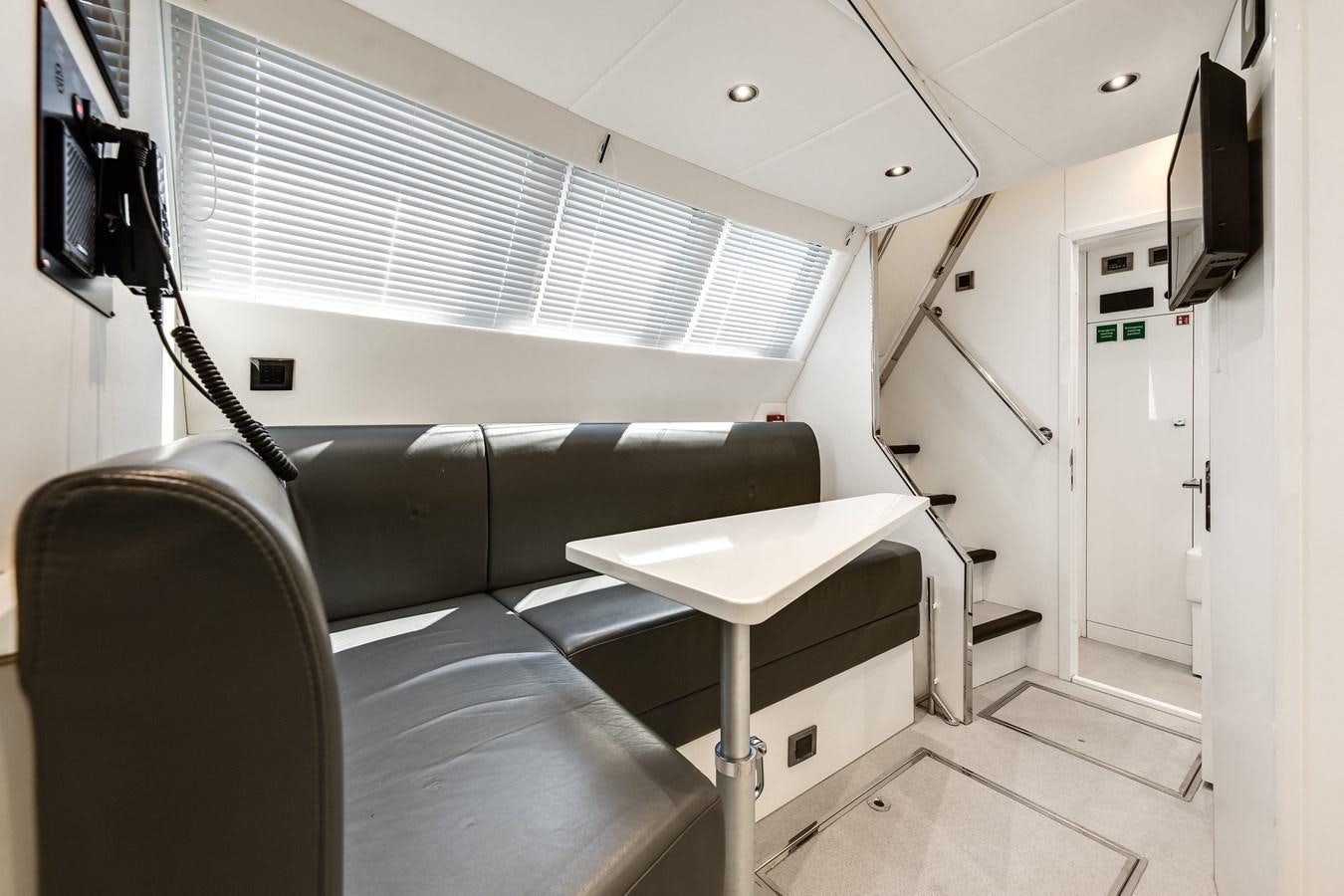 a room with a bed and desk aboard TRIGGER HAPPY Yacht for Sale