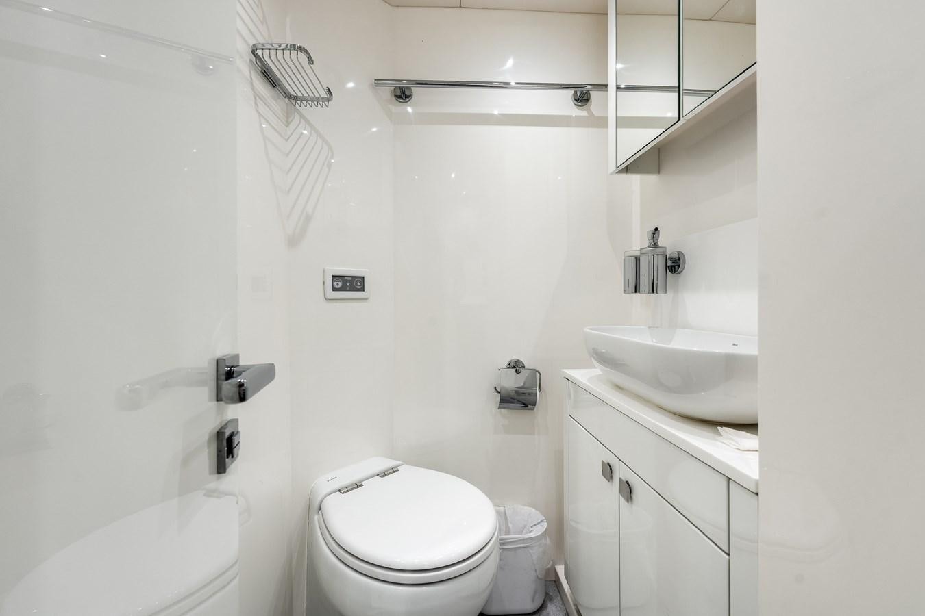 a bathroom with a sink toilet and a shower aboard TRIGGER HAPPY Yacht for Sale