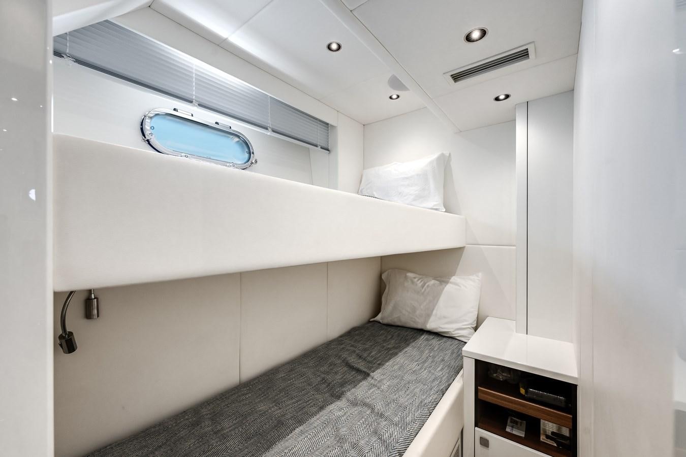 a room with a bed and a window aboard TRIGGER HAPPY Yacht for Sale