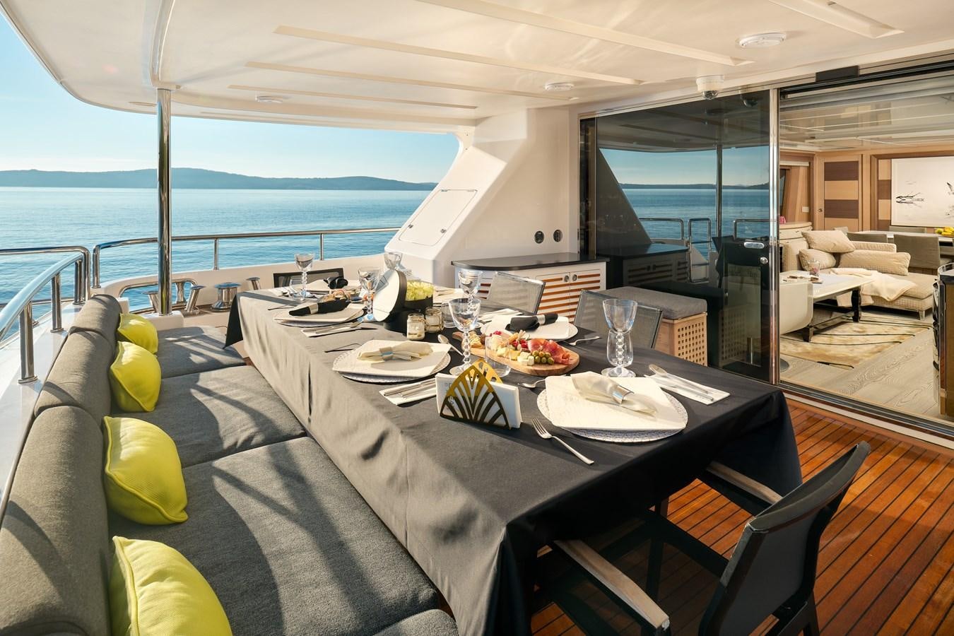 a table with plates and glasses on it aboard OCEAN DRIVE Yacht for Sale