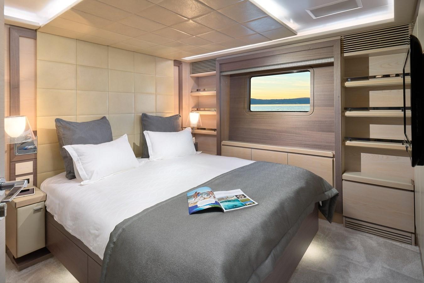 a bed with a white sheet and pillows aboard OCEAN DRIVE Yacht for Sale