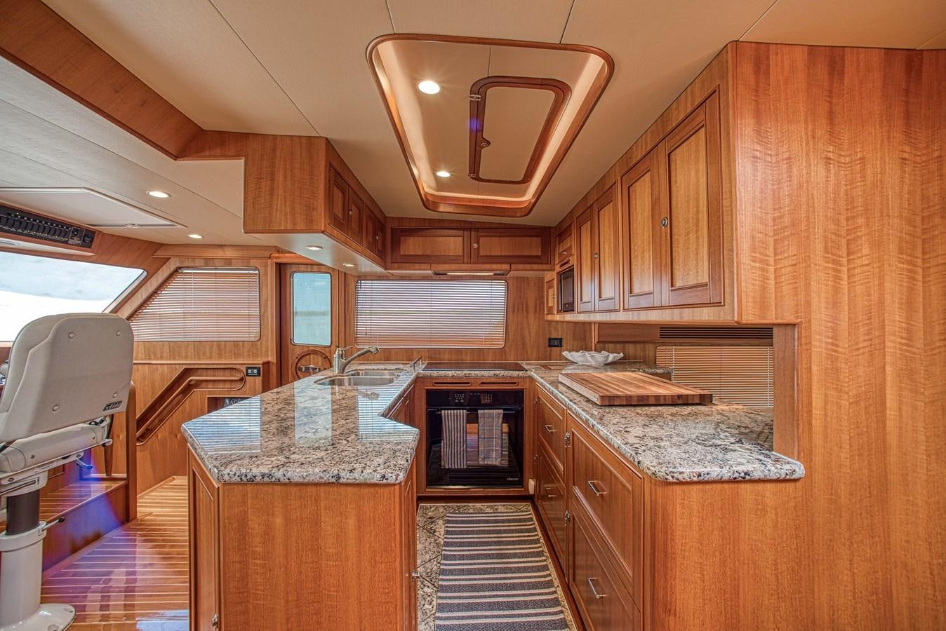 a kitchen with wooden cabinets aboard TRUE NORTH Yacht for Sale