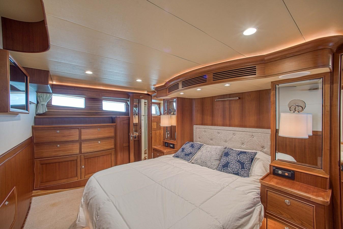 a bedroom with a bed and a dresser aboard TRUE NORTH Yacht for Sale