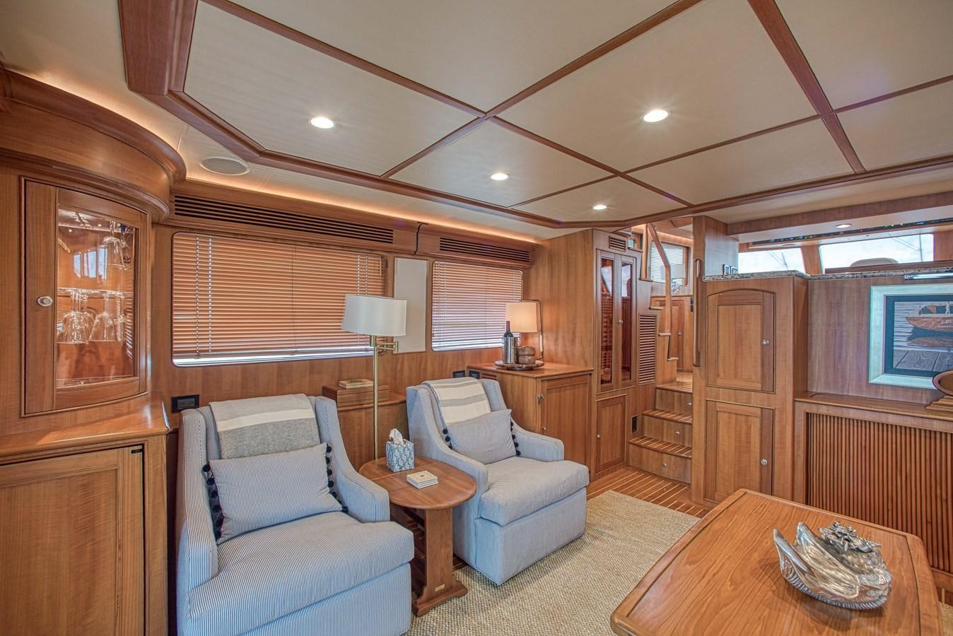 a living room with wood furniture aboard TRUE NORTH Yacht for Sale