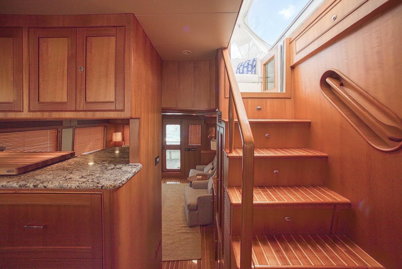 a kitchen with wooden cabinets aboard TRUE NORTH Yacht for Sale