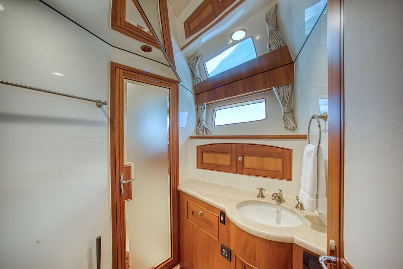 a bathroom with a sink and a mirror aboard TRUE NORTH Yacht for Sale