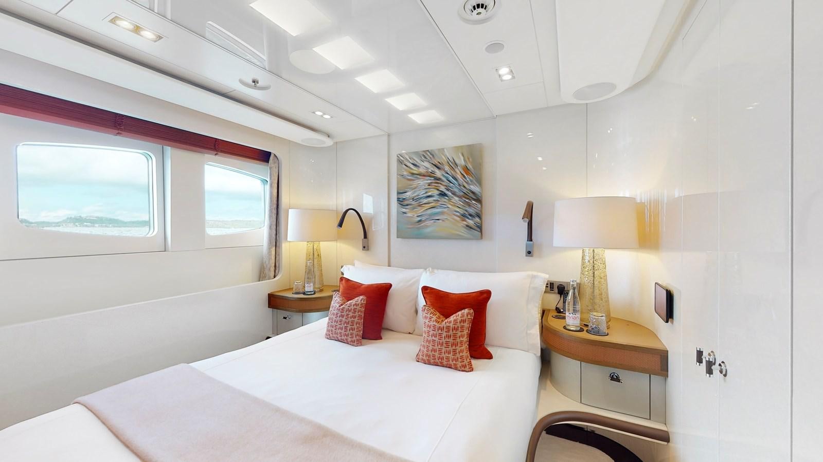 a bedroom with a bed and a lamp aboard AFTER YOU Yacht for Sale