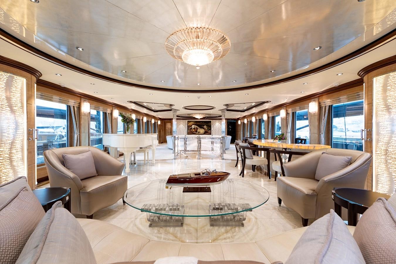 a large living room with a large table and chairs aboard QUEEN MAVIA Yacht for Sale