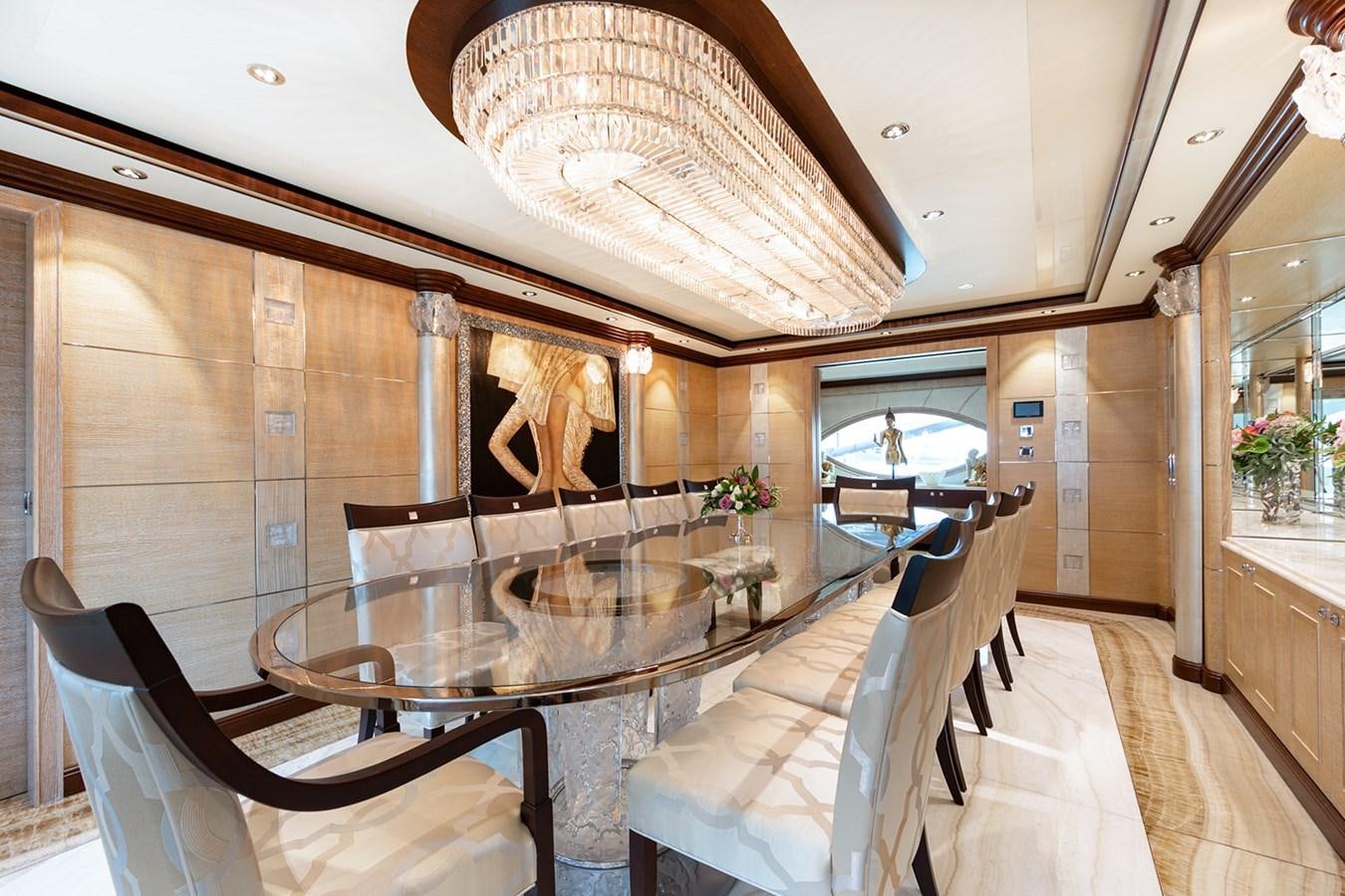 a large dining room with a chandelier aboard QUEEN MAVIA Yacht for Sale