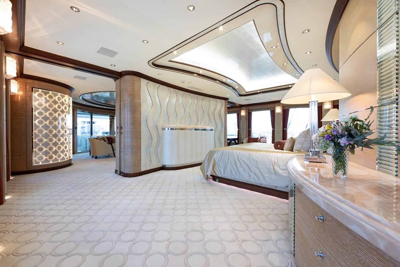 a room with a bed and a table aboard QUEEN MAVIA Yacht for Sale