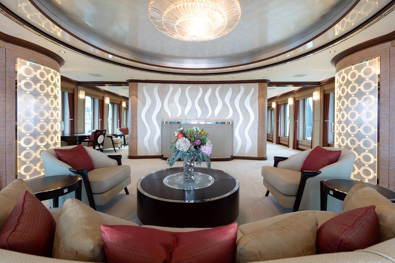 a large living room with a chandelier aboard QUEEN MAVIA Yacht for Sale