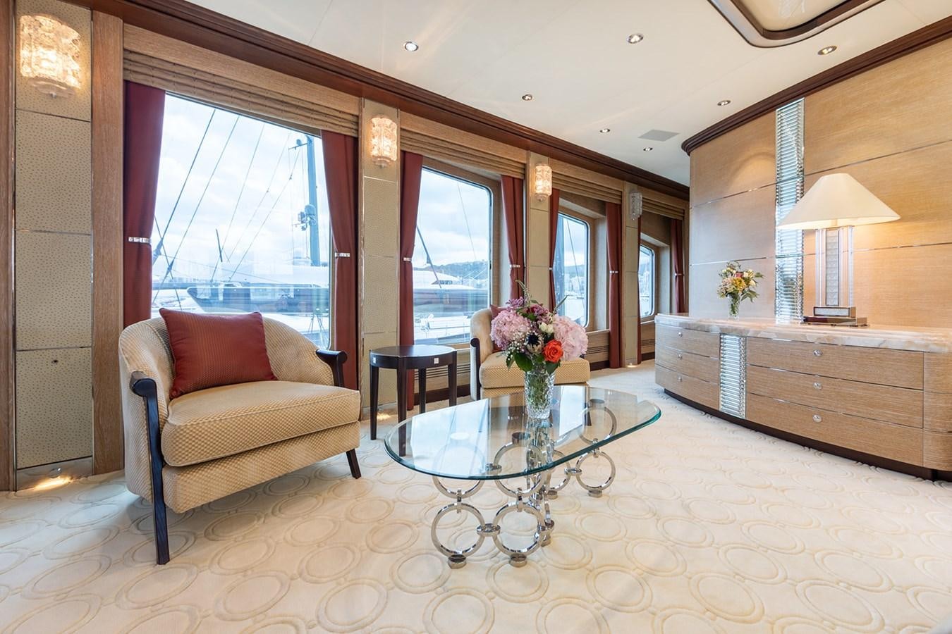 a living room with a table and chairs aboard QUEEN MAVIA Yacht for Sale