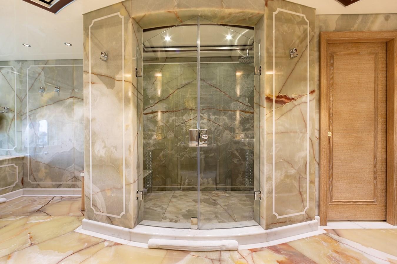 a bathroom with glass walls aboard QUEEN MAVIA Yacht for Sale