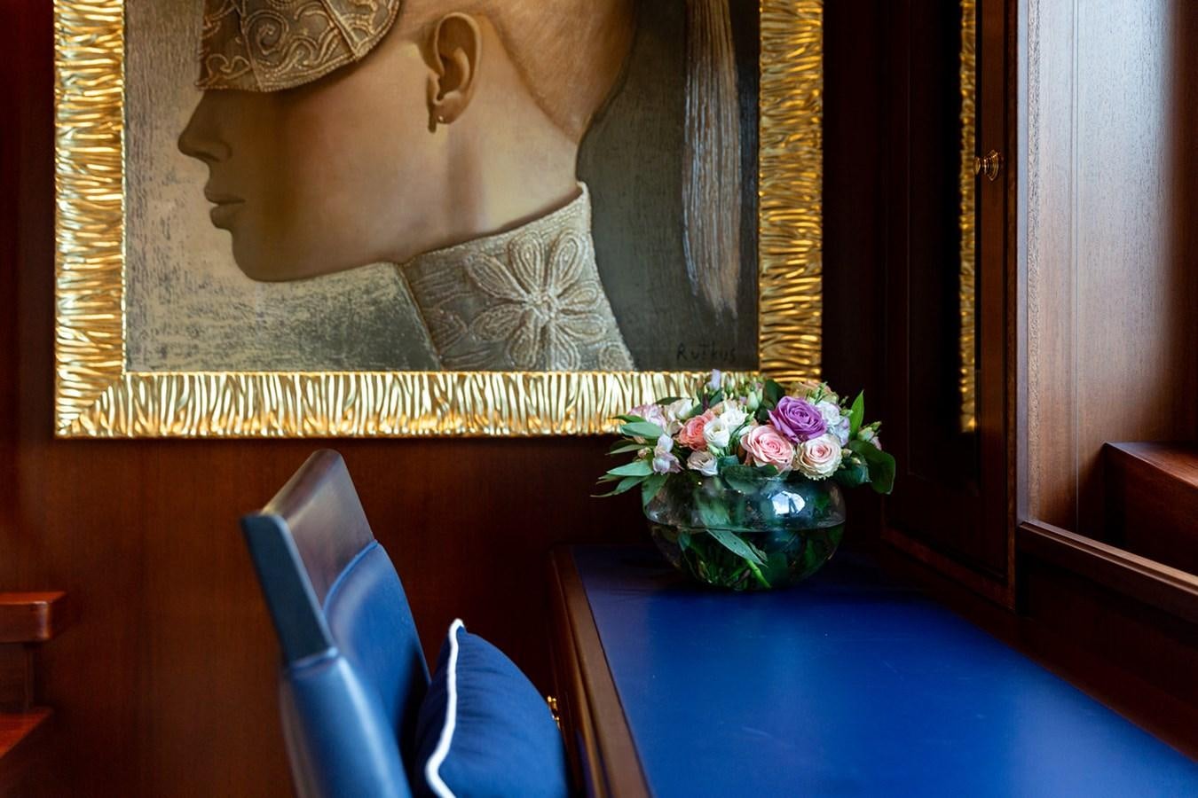 a vase of flowers on a table aboard QUEEN MAVIA Yacht for Sale