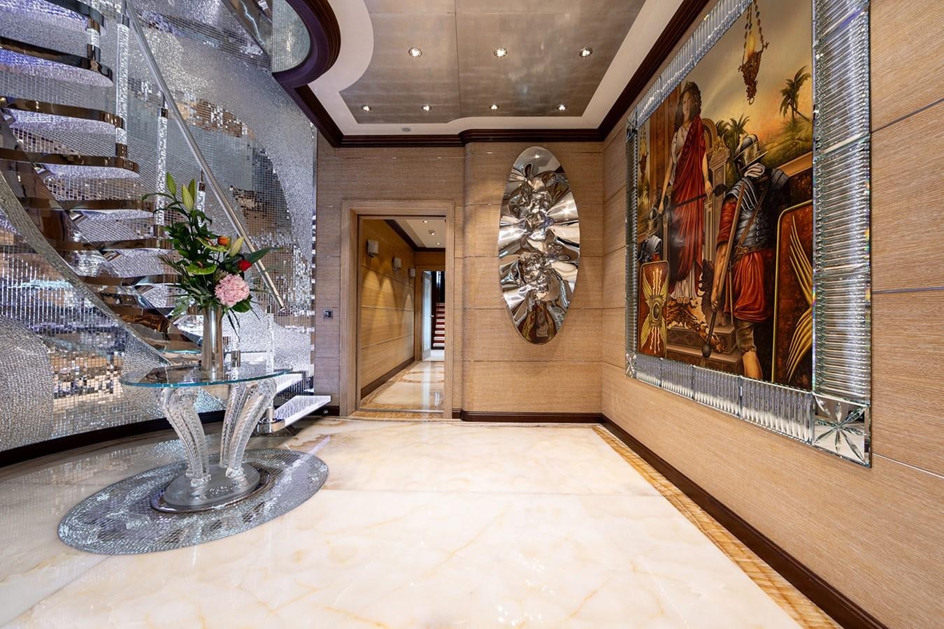 a room with paintings and a fountain aboard QUEEN MAVIA Yacht for Sale