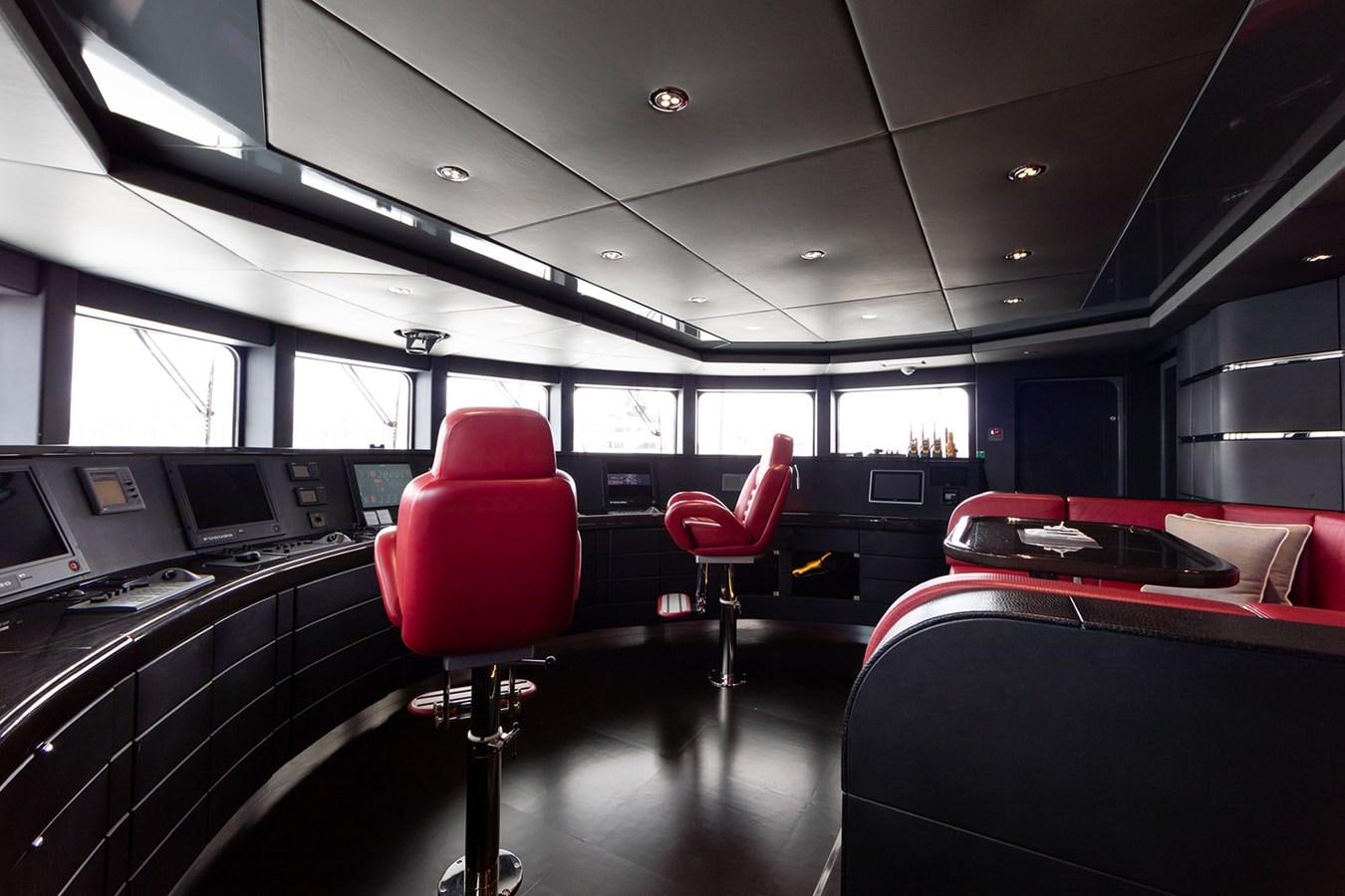 a room with seats and a table aboard QUEEN MAVIA Yacht for Sale