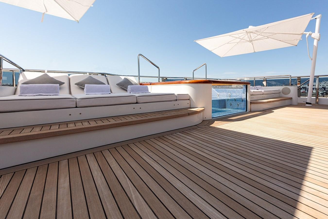 a deck with a boat on it aboard QUEEN MAVIA Yacht for Sale