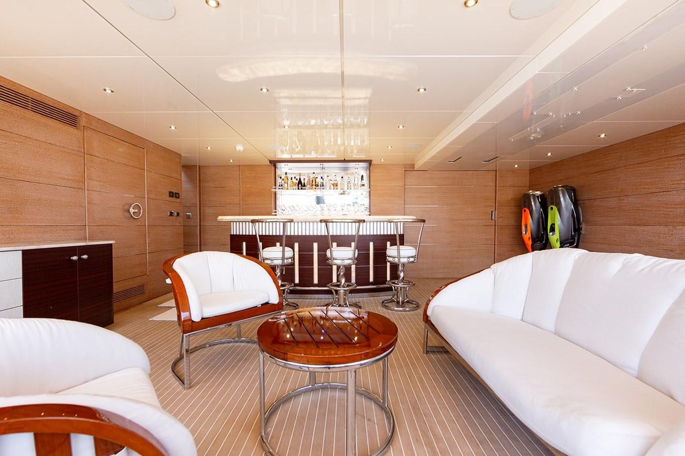 a room with a table and chairs aboard QUEEN MAVIA Yacht for Sale