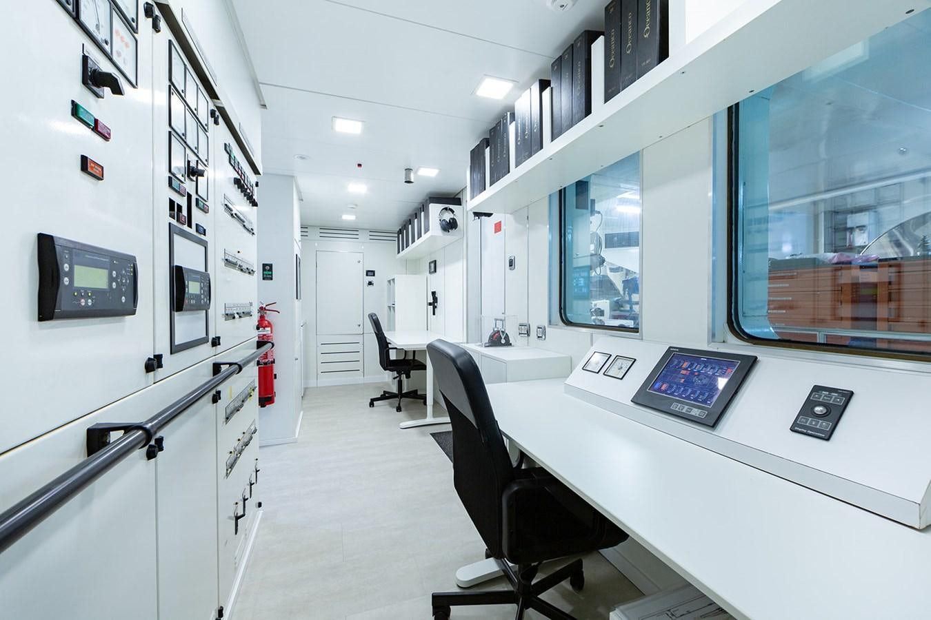 a room with a desk and chairs aboard QUEEN MAVIA Yacht for Sale