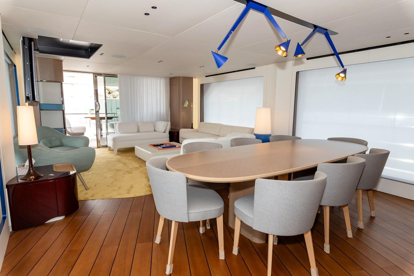 a large living room with a dining table and a large window aboard AZIMUT GRANDE 26/25 Yacht for Sale